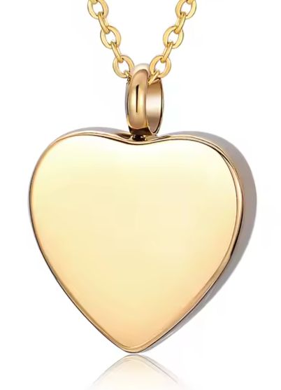 Polished gold heart cremation jewelry pendant with matching chain, designed as a personalized urn necklace to hold ashes securely.