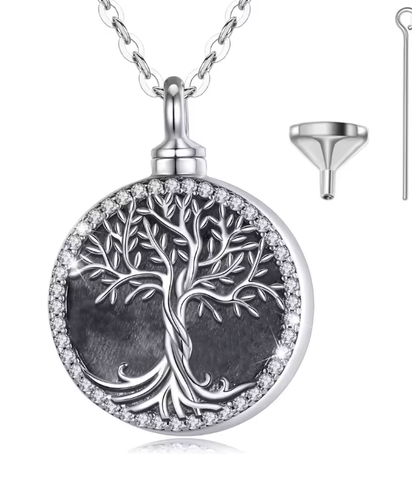 Silver circular Tree of Life memorial urn pendant with crystal border and filling funnel kit on white background.