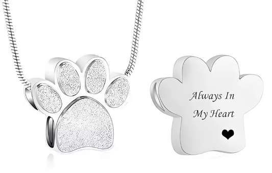 Silver paw print cremation necklace with engraved back reading Always In My Heart. Pet memorial keepsake jewelry.